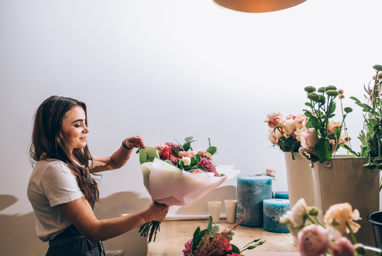 Smiling tenant standing in her flower shop at a commercial building