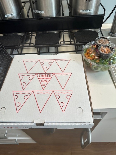 Pizza box and salad from Timber Pizza Co. at High Park Village, a commercial property managed by York Properties in Raleigh, NC.